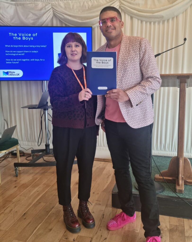 Jade and Lee at the VoB Launch Jade, the author of the report and Lee, who conducted the research, holding the Voice of the Boys report up between them.