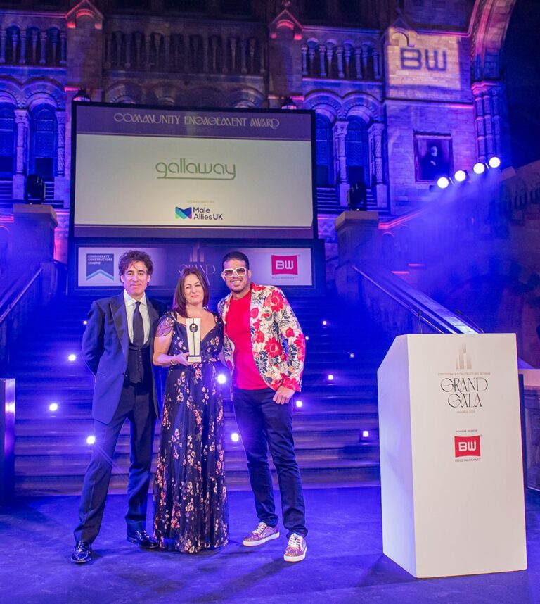 Lee on stage with two people at the CCS Grand Gala.