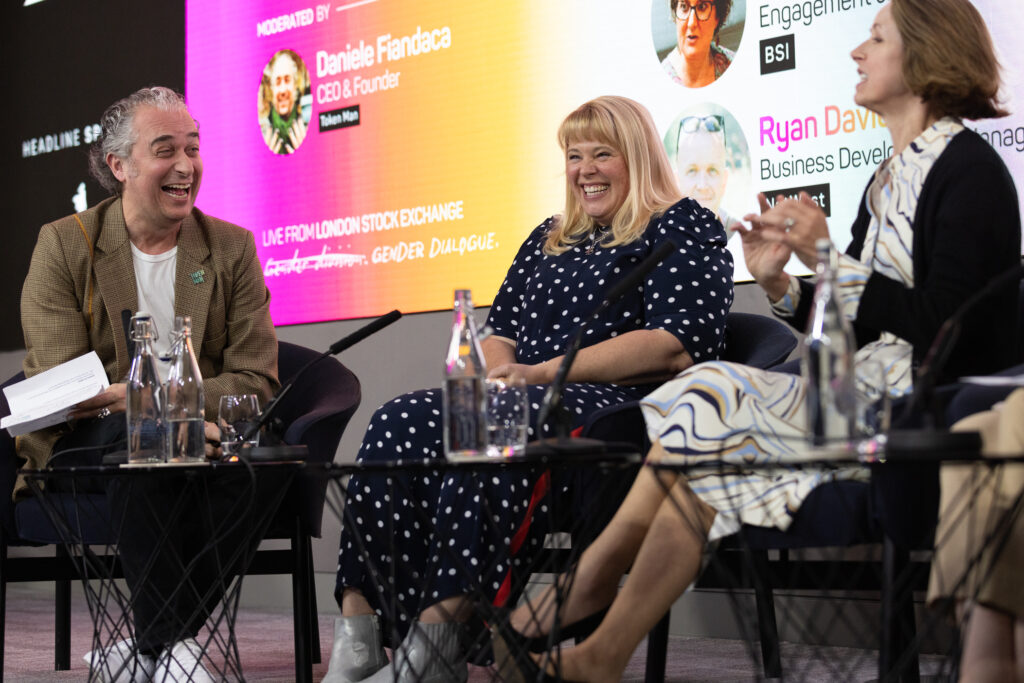 Panel members at Male Allies UK's National Allyship Summit laughing together on stage.